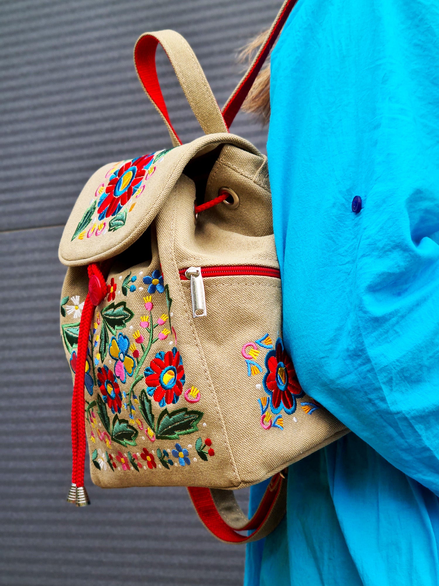 Backpack with "Unconquered" embroidery, beige