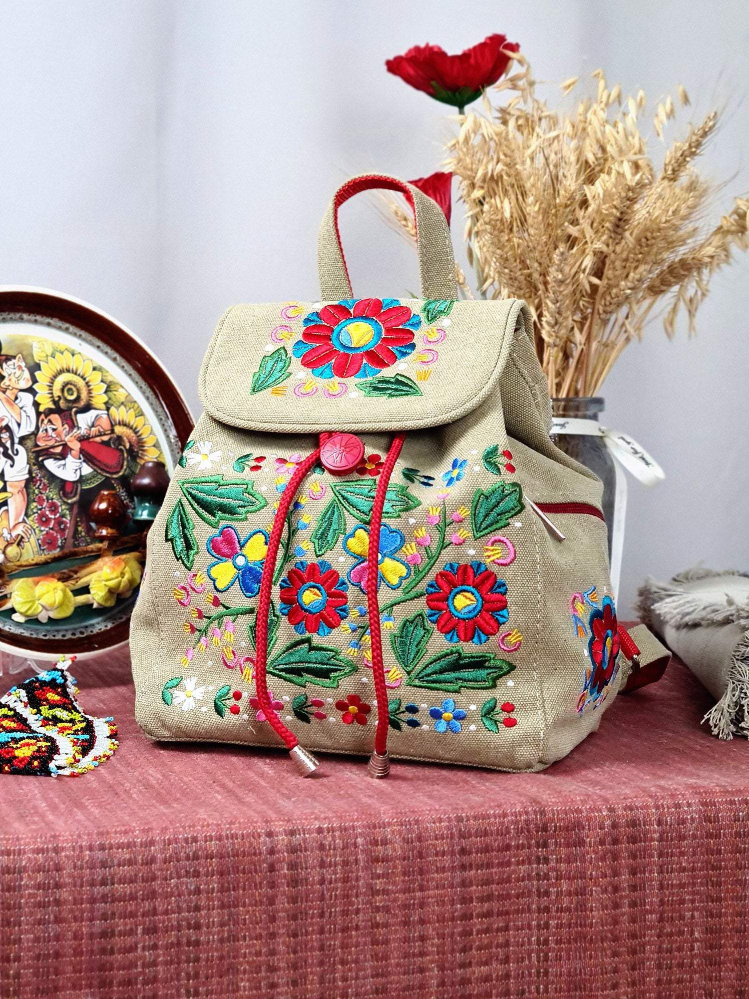 Backpack with "Unconquered" embroidery, beige