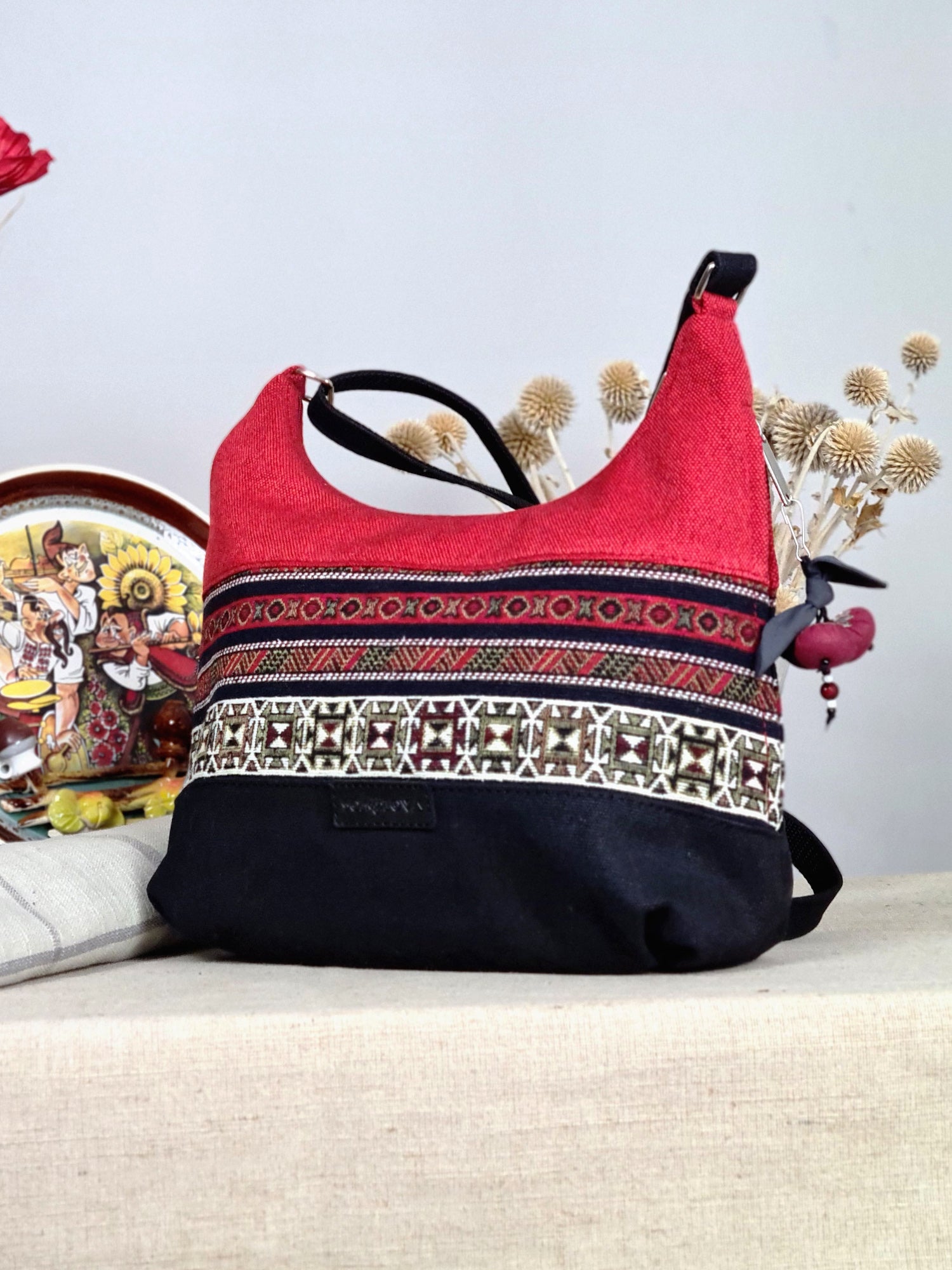 The bag is red and black with ethnic ornament