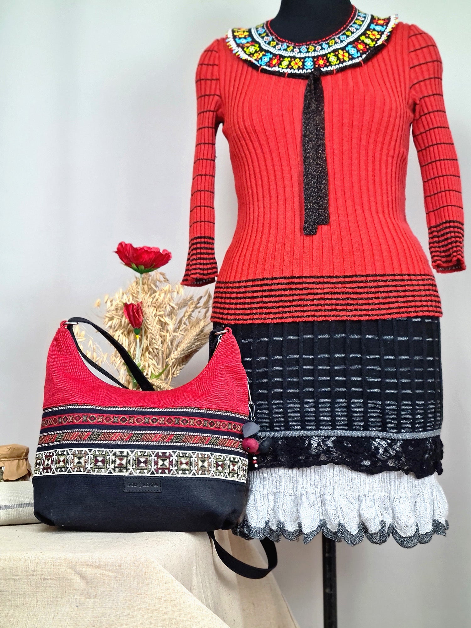 The bag is red and black with ethnic ornament