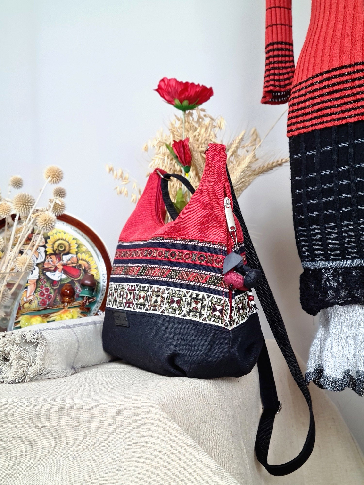 The bag is red and black with ethnic ornament