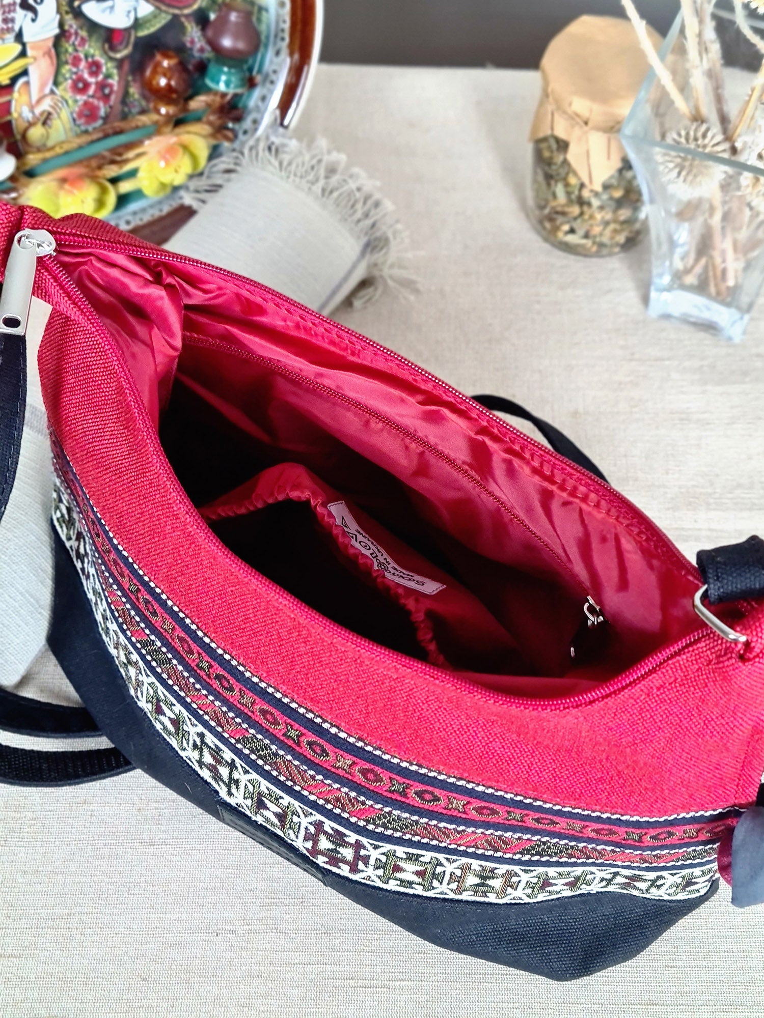 The bag is red and black with ethnic ornament