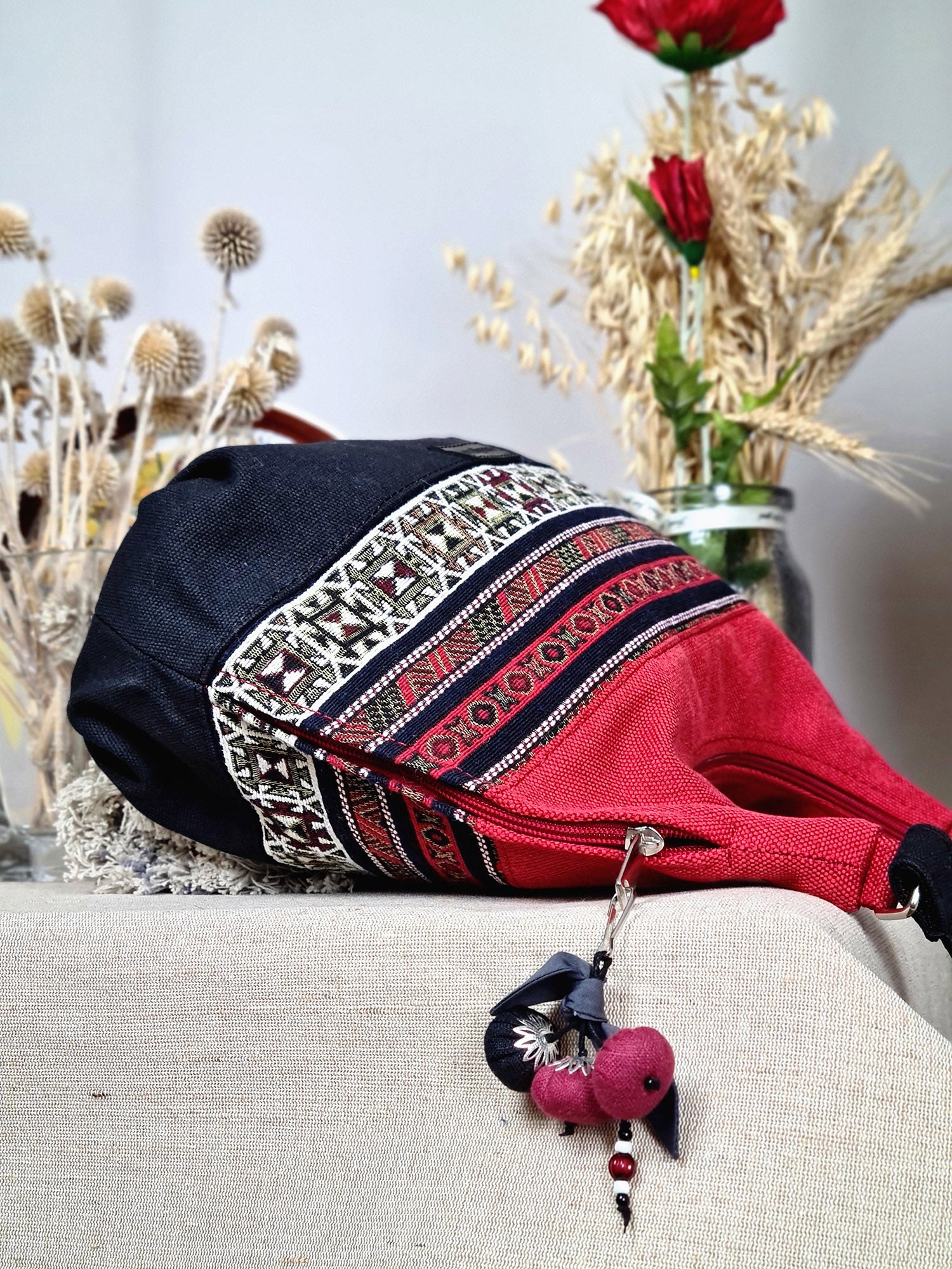The bag is red and black with ethnic ornament