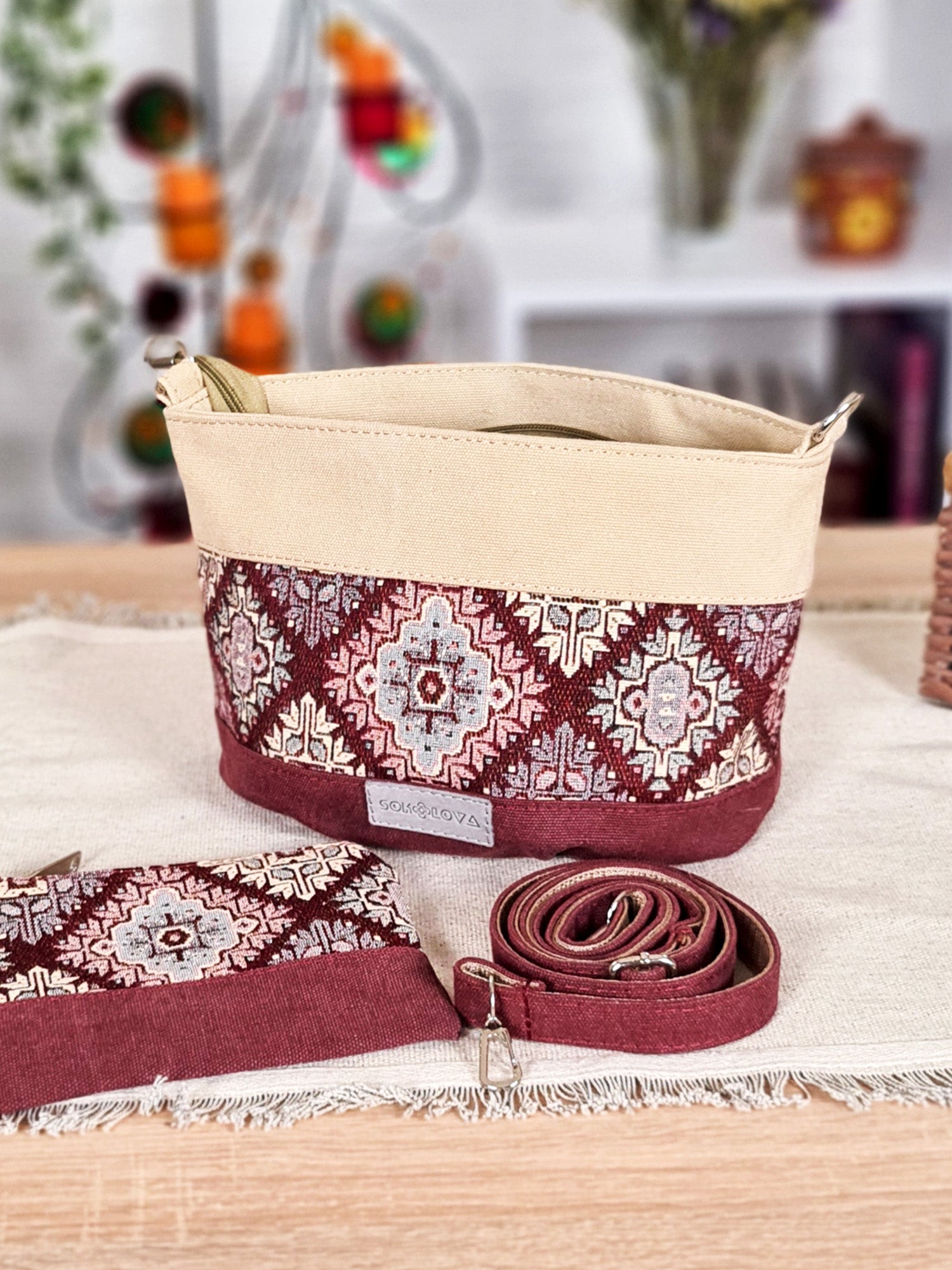 A small bag with a burgundy ornament