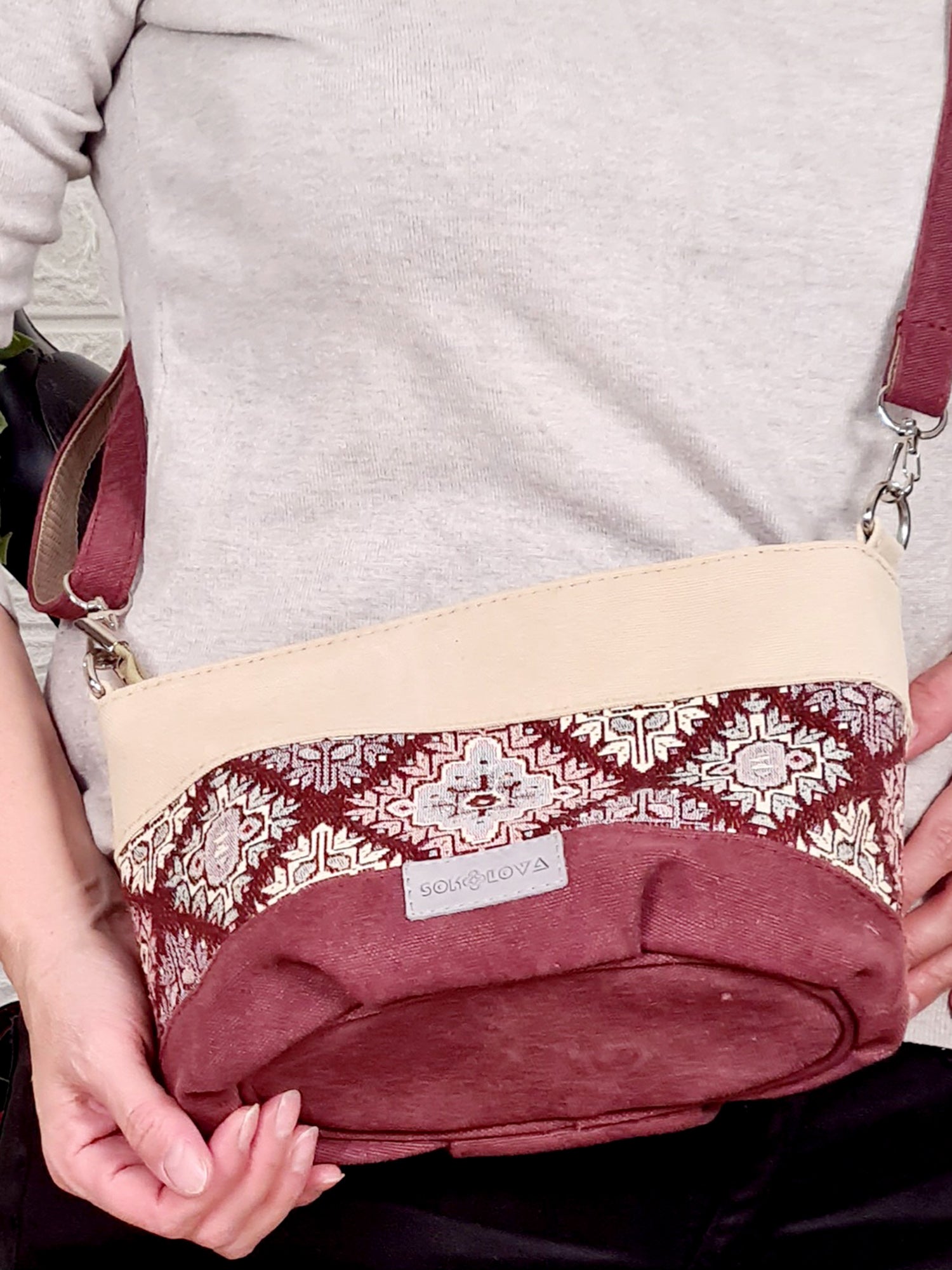 A small bag with a burgundy ornament
